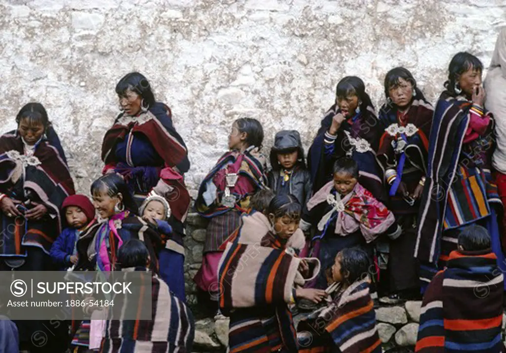 WOMEN and children in DOLPO BLANKETS gather at a Tibetan Buddhist FESTIVAL in the DO TARAP VALLEY - DOLPO, NEPAL