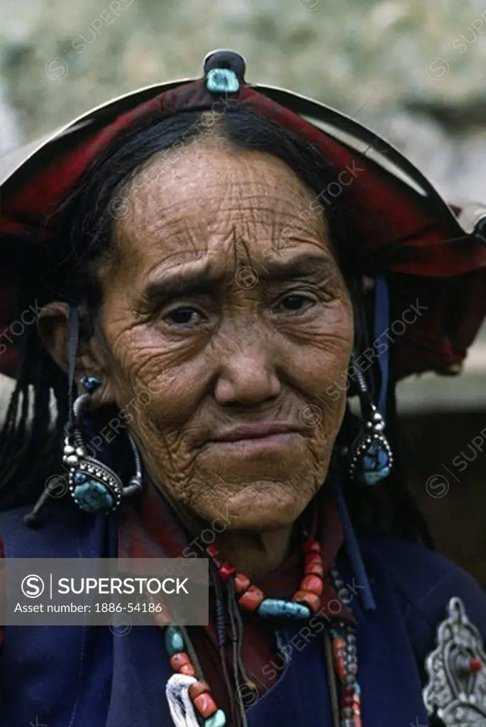 WOMAN with old style HEAD PEICE and silver clasp at a Tibetan Buddhist FESTIVAL in the DO TARAP VALLEY - DOLPO DISTRICT, NEPAL