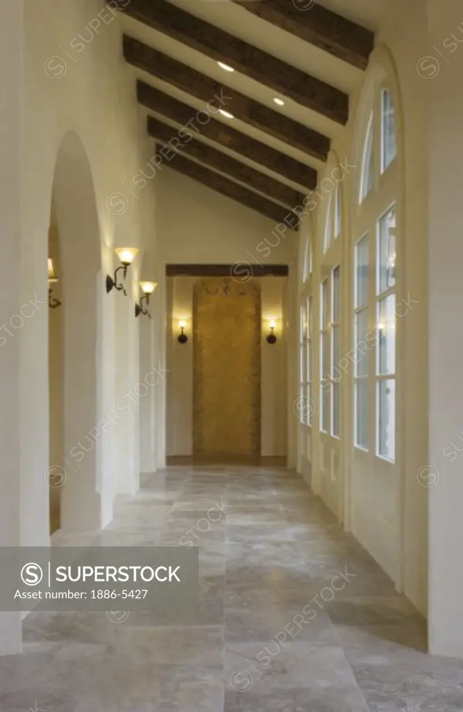 STONE FLOOR and hallway with interior lighting fixtures and multi-paned windows  - CALIFORNIA LUXURY HOME