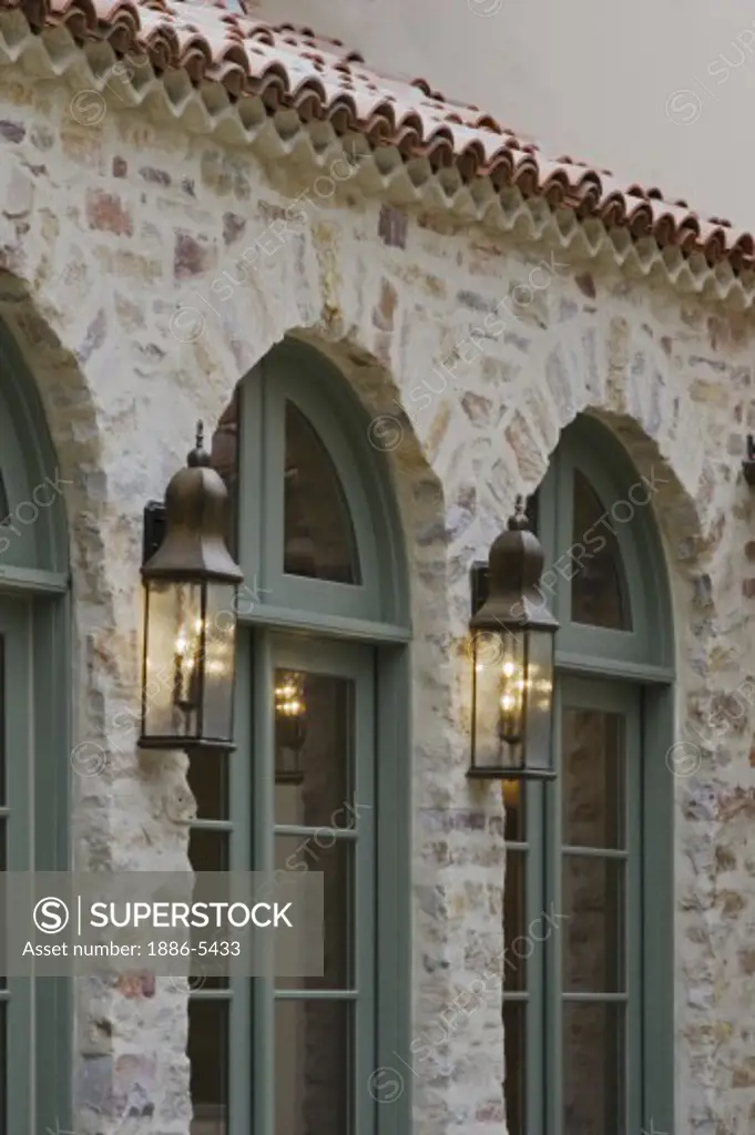 Full length wooden WINDOWS set in CARMEL STONE with outdoor lighting - CALIFORNIA LUXURY HOME