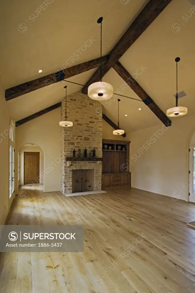 HARD WOOD FLOOR, STONE FIREPLACE, built in CABINETS, OPEN BEAM CEILING & LIGHT FIXTURES in a  LIVING ROOM - CALIFORNIA LUXURY HOME