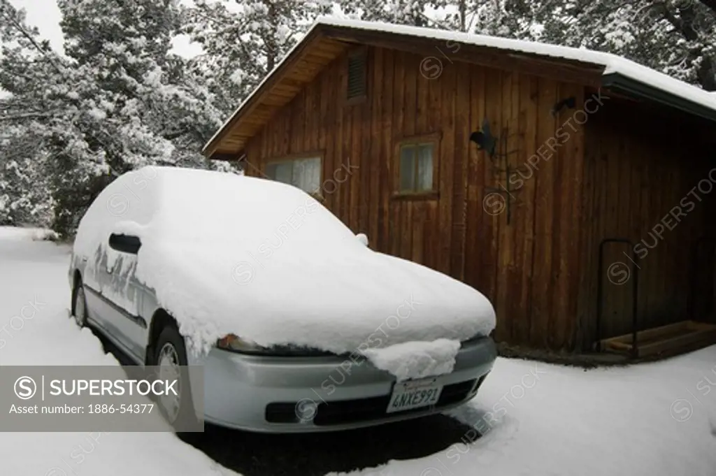 Snow covers a Subaru Legacy station wagon during a winter storm - OREGON
