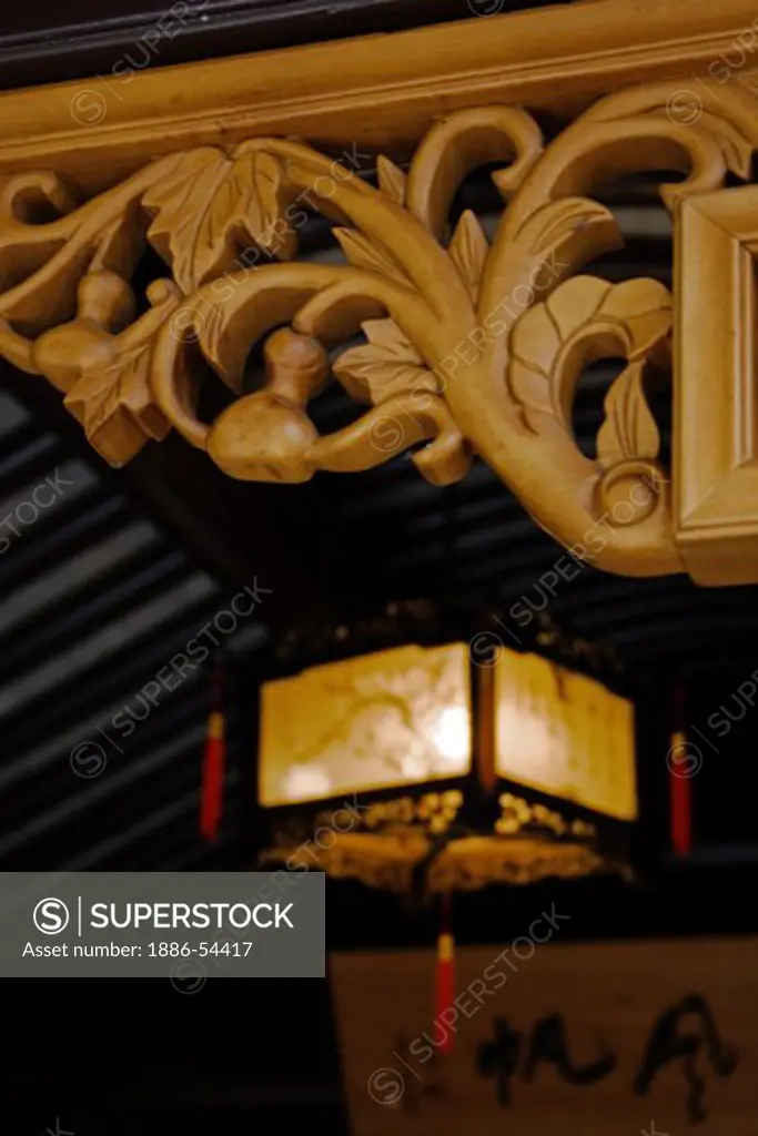 Ornately carved woodwork & Japanese lantern at the Portland Classical Chinese Garden,  an authentically built Ming Dynasty style garden - PORTLAND, OREGON