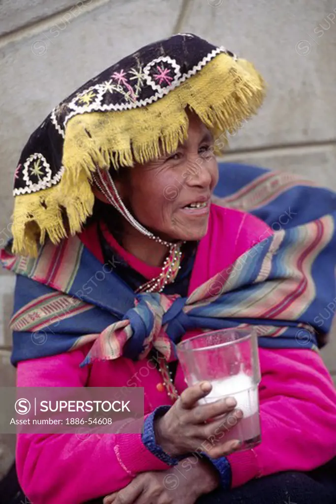 QUECHUA woman drinks the local brew in a rural town near our destination of AUZANGATE - PERU