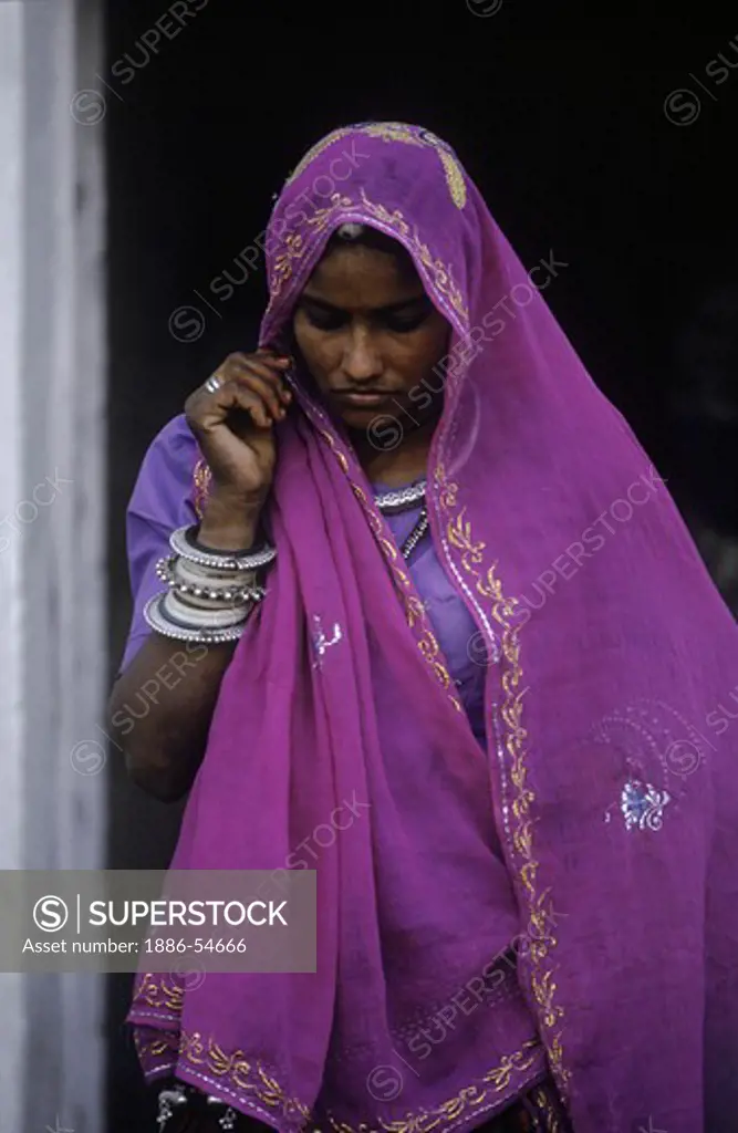 Beautiful INDIAN WOMAN with SILVER BRACELETS and HEAD SHAWL  at the PUSHKAR CAMEL FAIR- RAJASTHAN, INDIA