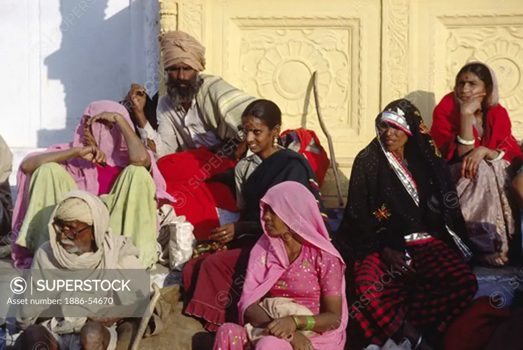 PILGRIMS on the steps of OLD RANGJI TEMPLE at the PUSHKAR CAMEL FAIR, a 5 day religious festival - RAJASTHAN, INDIA
