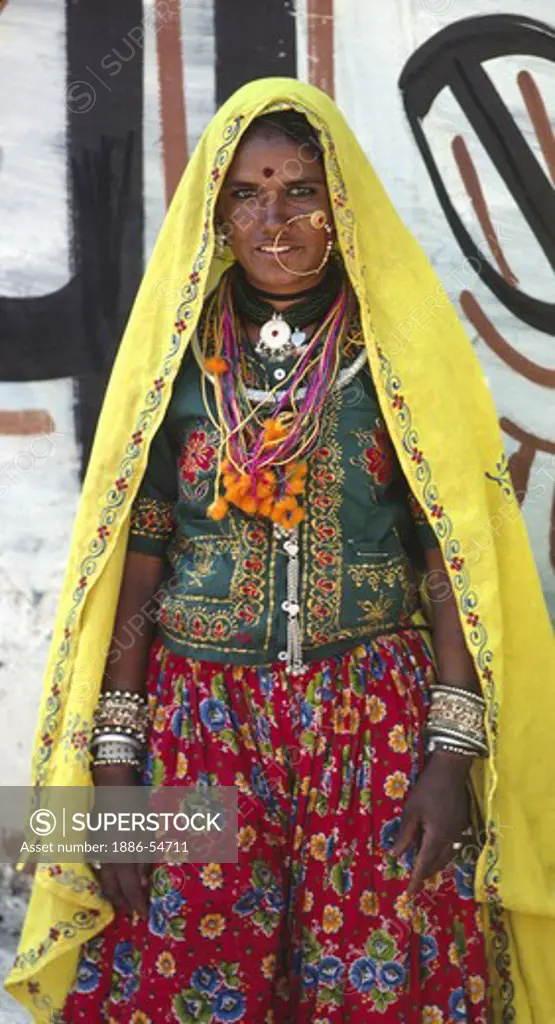 Portrait of a BANJARI WOMAN with a gold NOSE RING in tribal attire at the PUSHKAR CAMEL FAIR - RAJASTHAN, INDIA