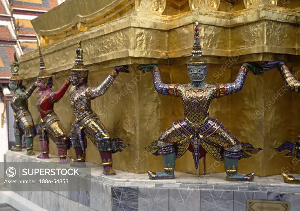 Statues of BUDDHIST DIETIES support a temple at WAT PHRA KEO in the GRAND PALACE - BANGKOK, THAILAND