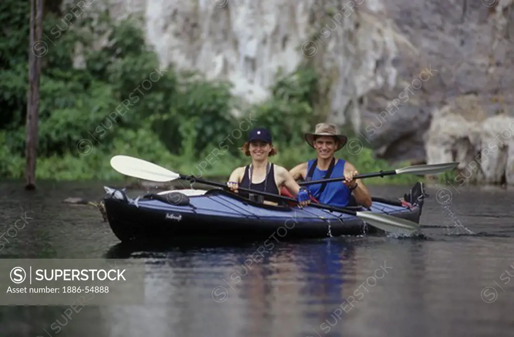 KAYAKING in KHAO SOK NATIONAL PARK, a large reservoir surrounded by limestone cliffs in a rain forest - THAILAND