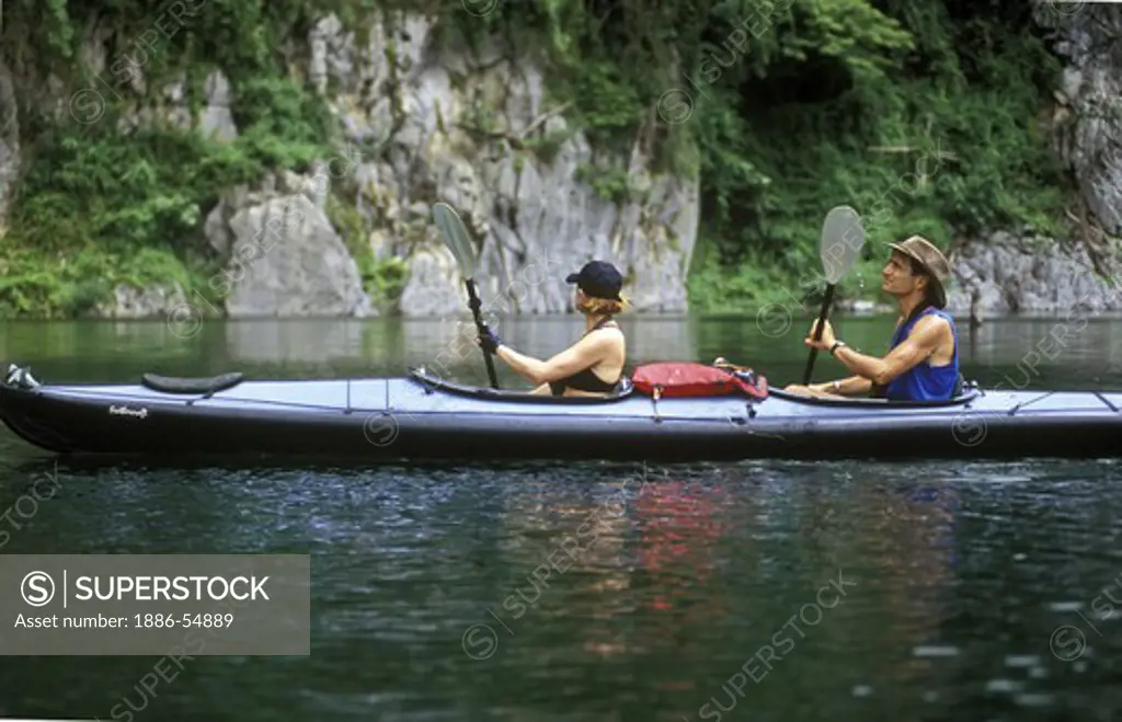 KAYAKING in KHAO SOK NATIONAL PARK, a large reservoir surrounded by limestone cliffs in a rain forest - THAILAND