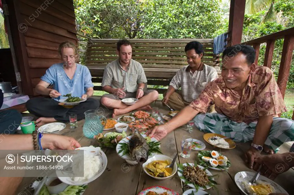 A feast of locally prepared food is shared with home stay eco-tourists in the village of Tung Nang Dam located on the North Andaman Sea - THAILAND