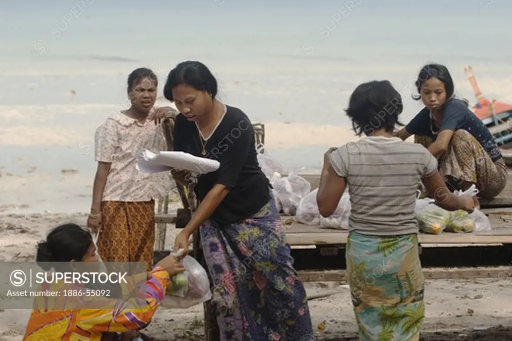 North Andaman Tsunami Relief staff deliver food to a Moken (sea gypsy) village of Ko Surin Thai Island in Mu Ko Surin National Park -  ANDAMAN SEA, THAILAND
