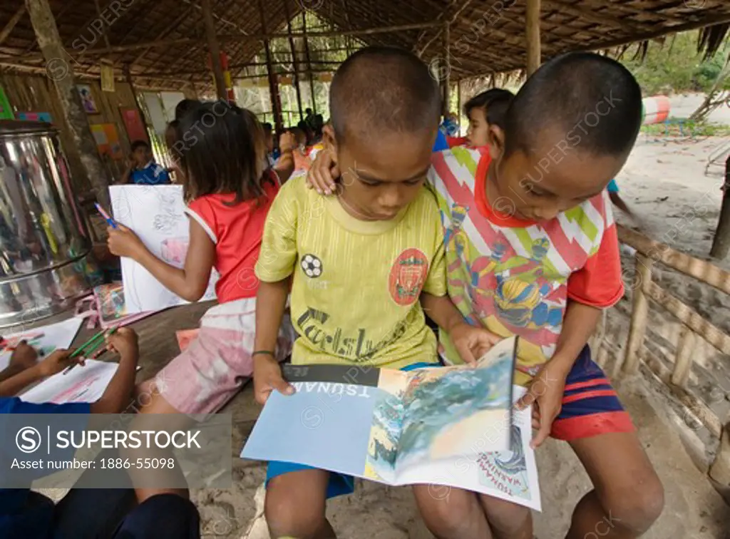 Moken children (sea gypsies) learn about tsunamis in their village on Ko Surin Thai Island in Mu Ko Surin National Park -  ANDAMAN SEA, THAILAND