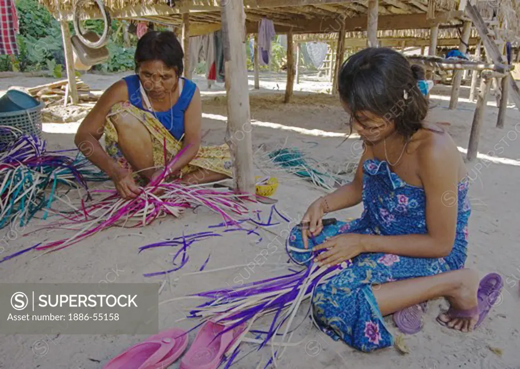 Moken (sea gypsy) women weave baskets out of plants in their village on Ko Surin Thai Island in Mu Ko Surin National Park -  ANDAMAN SEA, THAILAND