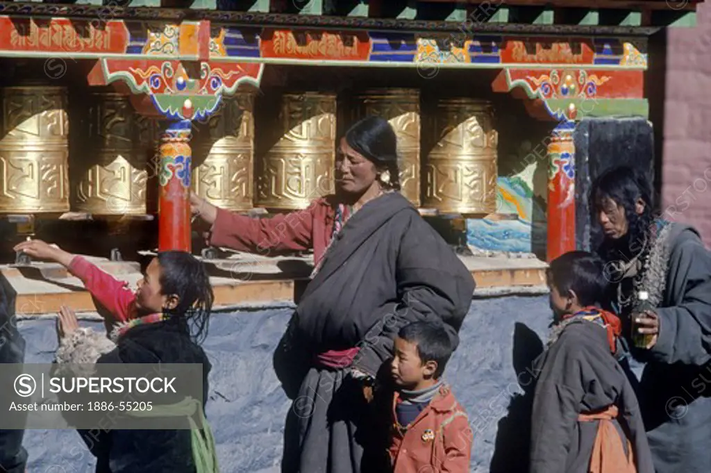 Pilgrims spin prayer wheels at Sakya Monastery - Sakya, Tibet.