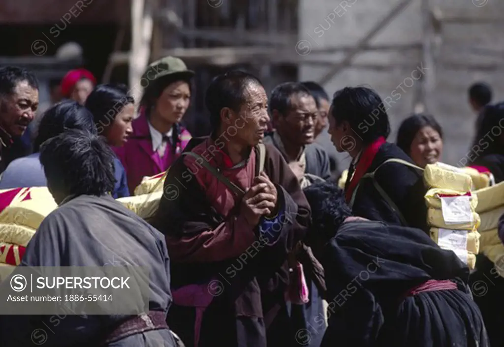 Monks carrying Buddhist scriptures on the Barkhor - Lhasa, Tibet