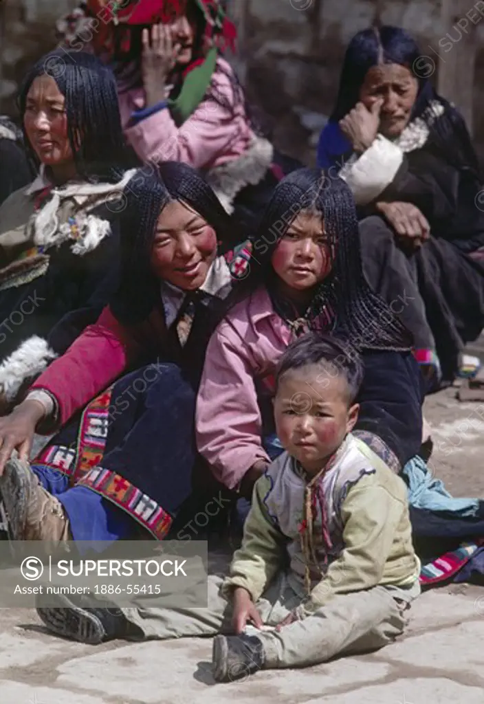 Tibetan pilgrims sporting 108 braids gather on the Barkhor - Lhasa, tibet