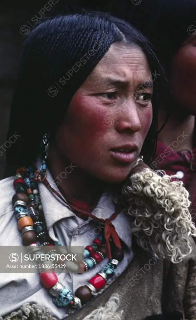 Tibetan pilgrim woman with beautiful jewelry & traditional 108 braids at Sera Monastery - Lhasa, Tibet