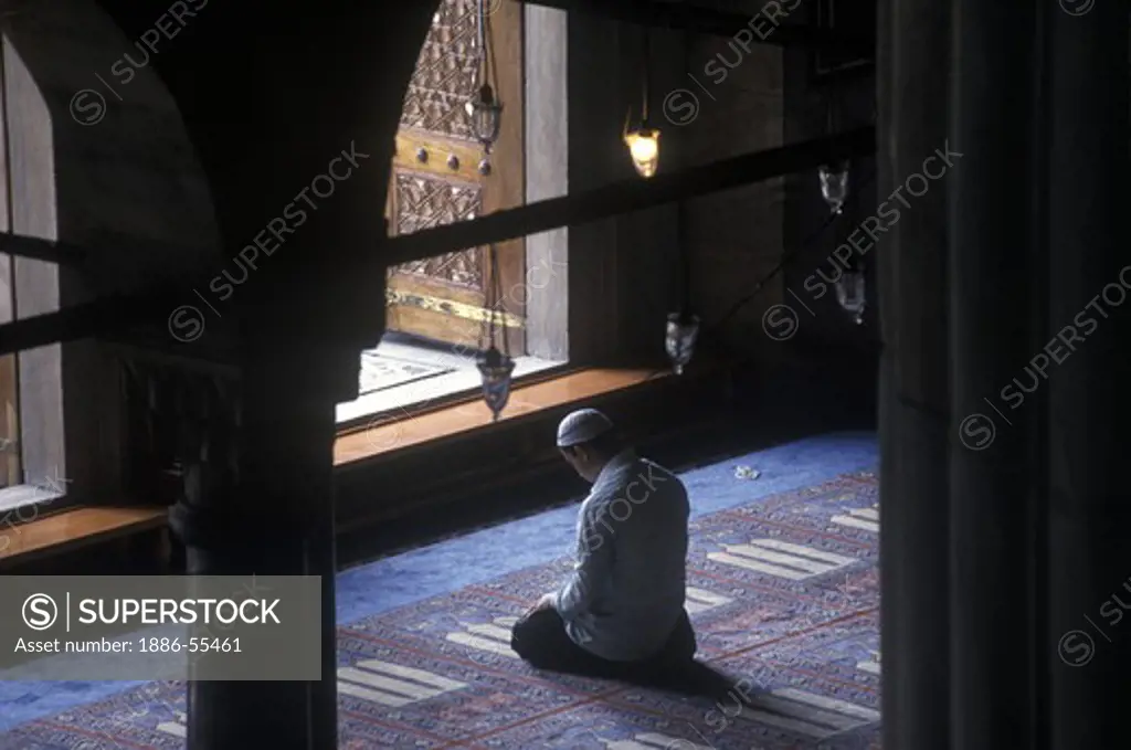A muslim prays inside the Blue Mosque, also called the Sultan Ahmet Camii. The mosque was completed in 1616 by Mehmet Aga and derives its name from the blue interior tilework. Istanbul, Turkey