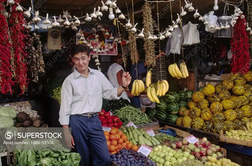 Young Turk sells fruits & vegtables in a covered market in the coastal town of FETHIYE - TURQUOISE COAST, TURKEY
