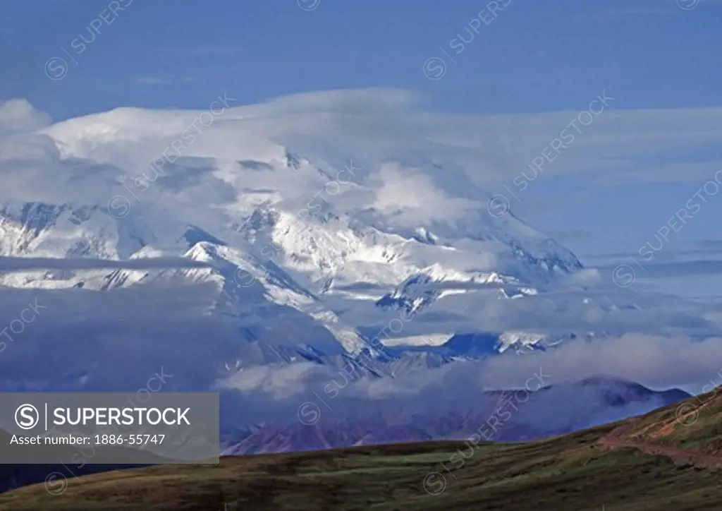 CLOUDS caress the peak of MOUNT MCKINLEY which rises to 20,320 feet - DENALI NATIONAL PARK, ALASKA