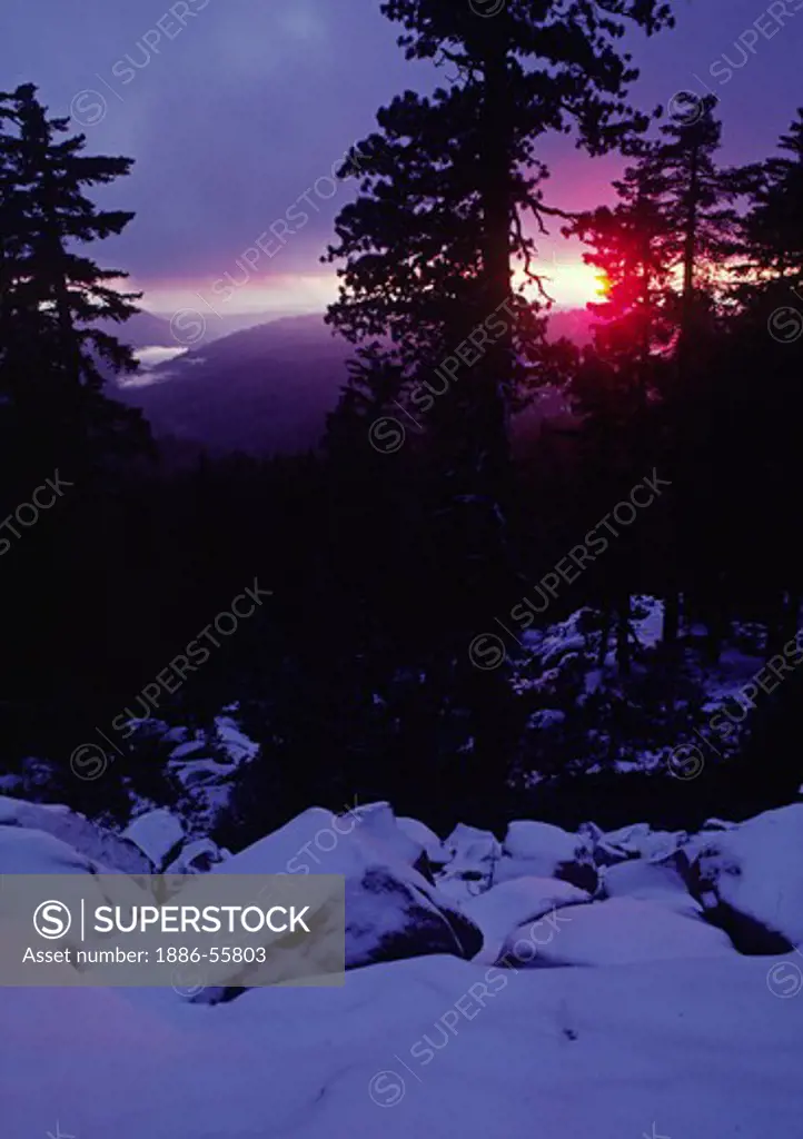 Sunsets over a winter landscape in CALIFORNIA'S SIERRA NEVADA MOUNTAINS