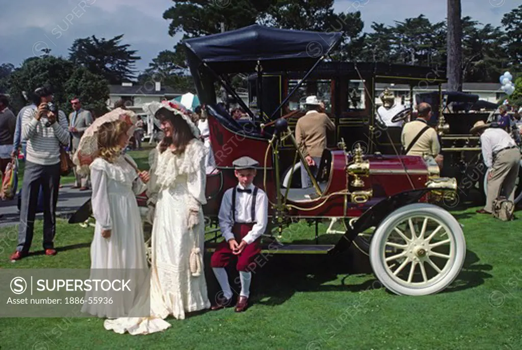 Attendees in period dress next to their 1900 PACKARD at the CONCOURSE D'ELEGANCE - PEBBLE BEACH, CALIFORNIA