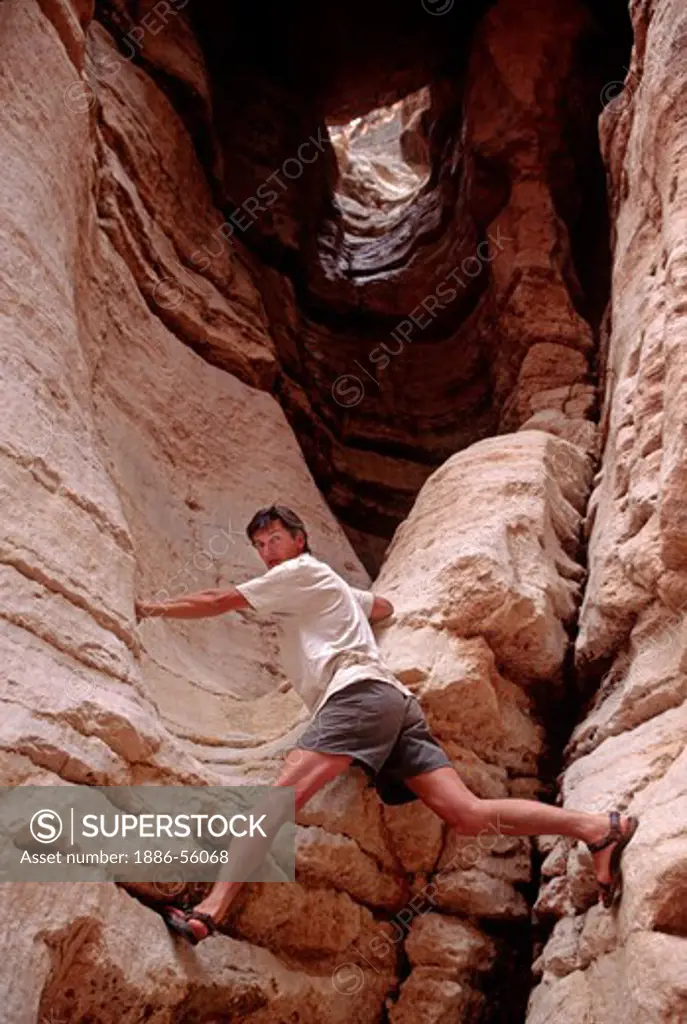 Man climbs (YONI ROCK FORMATION) formed from side drainage of DEER CREEK - GRAND CANYON NATIONAL PARK, ARIZONA (MR)
