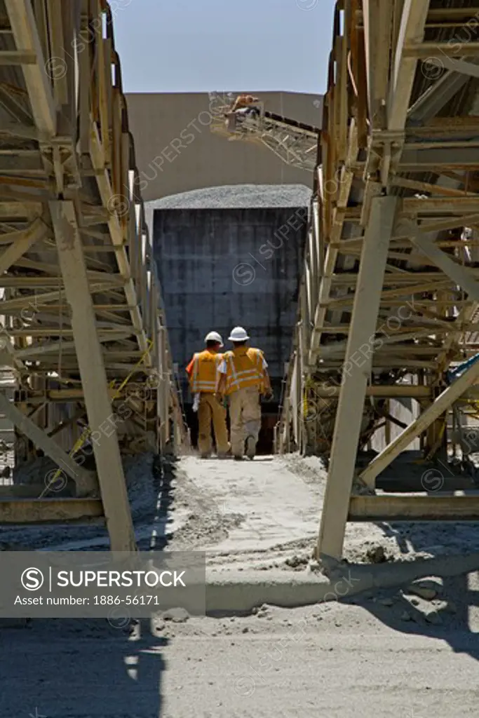 WORKERS wear HARD HATS near CONVEYER BELTS at the GRANITEROCK QUARRY  - AROMAS, CALIFORNIA