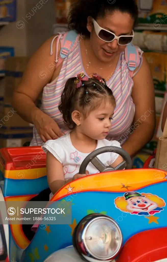 A MEXICAN MOTHER and CHILD in a TOY CAR RIDE  - GUANAJUATO,  MEXICO