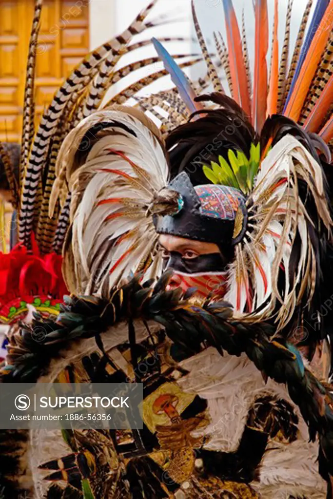 An AZTEC DANCER performs in a traditional warrior feathered COSTUME during the CERVANTINO FESTIVAL  - GUANAJUATO, MEXICO