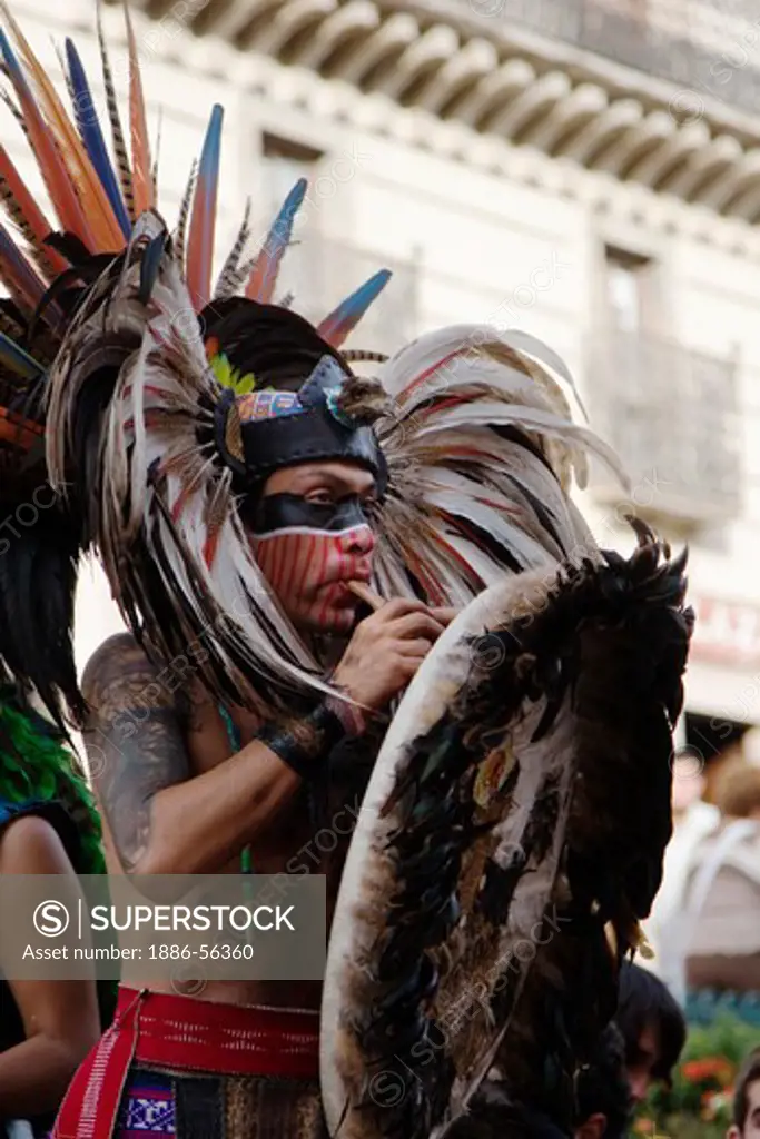 An AZTEC DANCER performs in a traditional warrior feathered COSTUME during the CERVANTINO FESTIVAL  - GUANAJUATO, MEXICO
