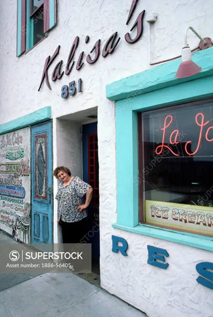Kalisa standing in doorway  of famous historic KALISA'S restaurant - CANNERY ROW, MONTEREY, CALIFORNIA