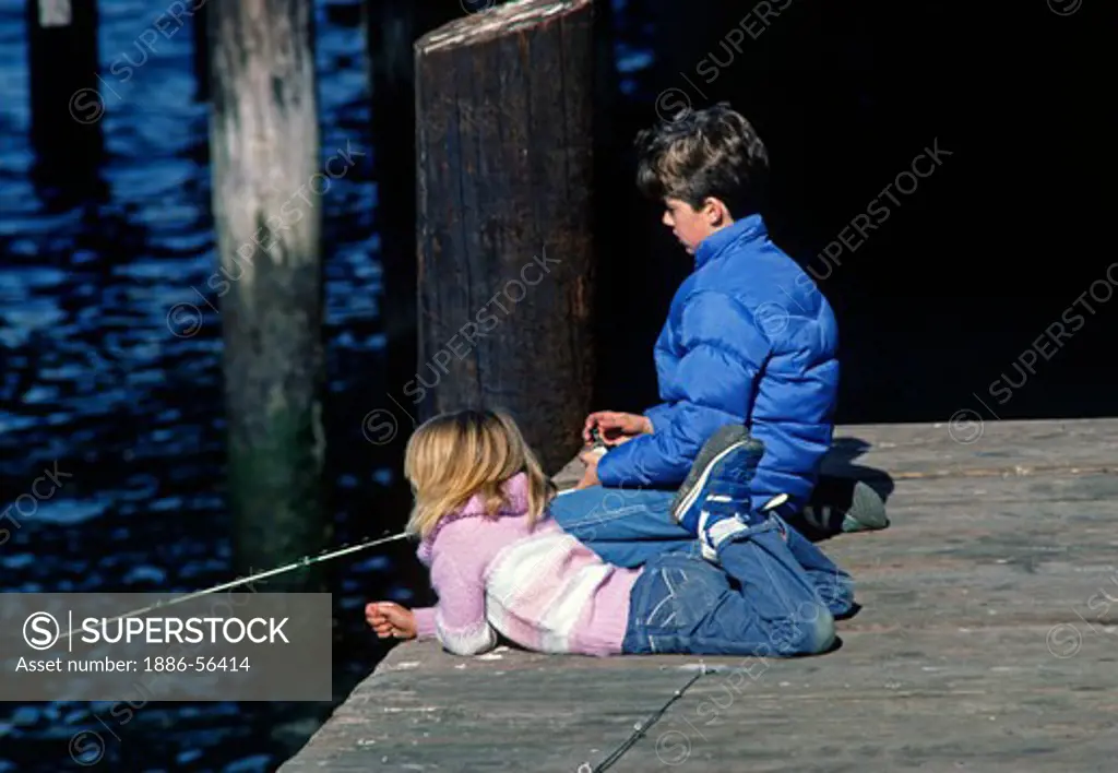 Children fish off the dock at MONTEREY HARBOR - CALIFORNIA