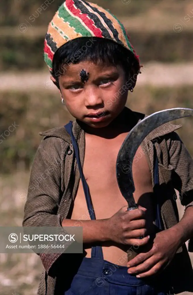Young NEPALI girl with sickle & black tika - SIKLIS TREK, NEPAL