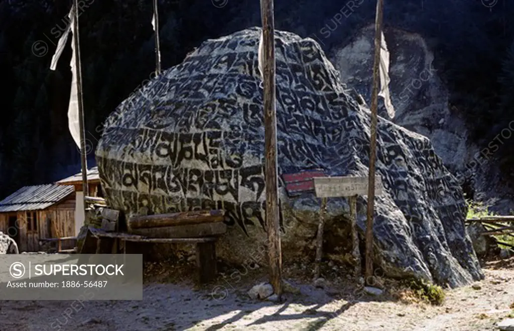 Rock is carved with the Buddhist prayer Om Mani Padme Hum 'Hail to the Jewel in the Lotus' - KHUMBU DISTRICT, NEPAL