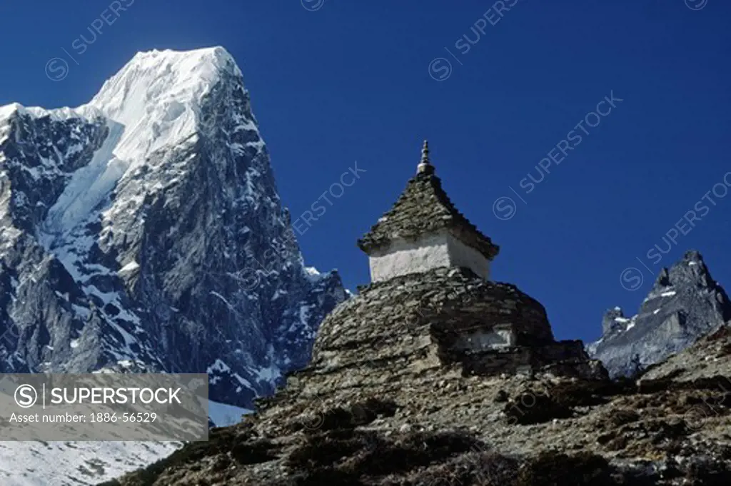 A Chorten & Himalayan peaks grace the skyline in the Everest Region - KHUMBU DISTRICT, NEPAL