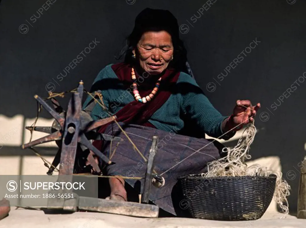 Village woman spins wool into thread - SIKLIS, NEPAL HIMALAYA