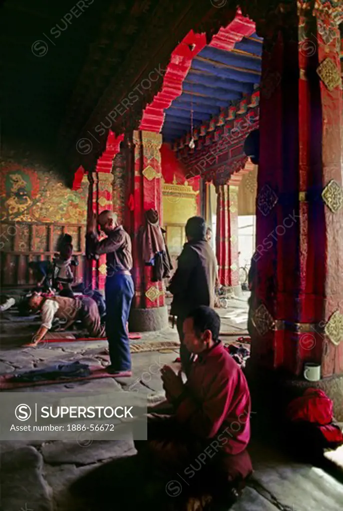 Tibetan pilgrims do prostrations in front of the Jokang Temple - LHASA, TIBET