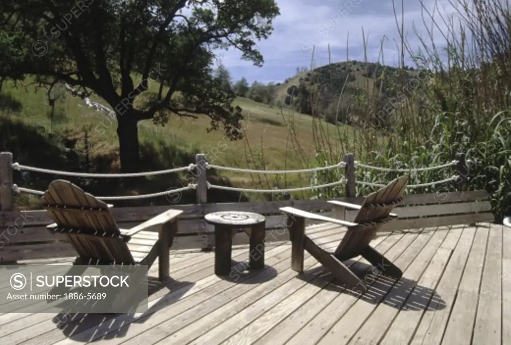 CHAIRS & DECK overlook the river at WILBUR HOT SPRINGS established in 1865 - CALIFORNIA