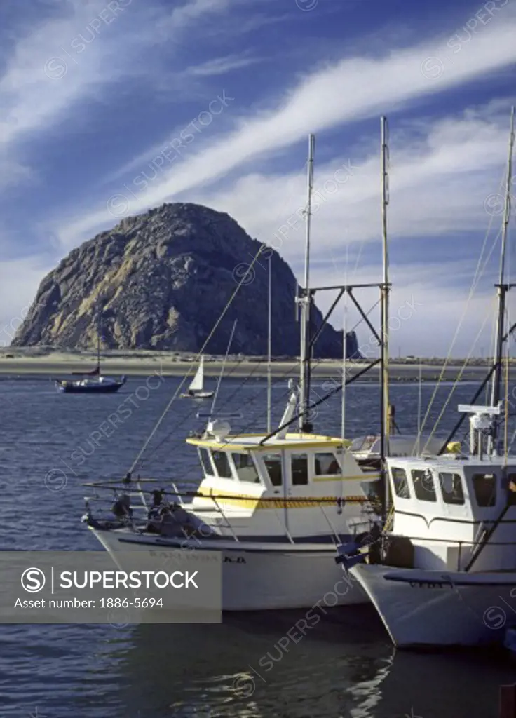 FISHING BOATS at anchor in MORRO BAY with MORRO ROCK in the background - CALIFORNIA