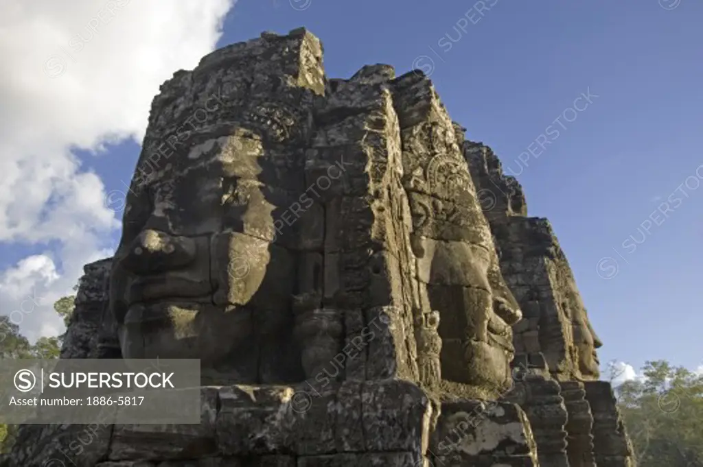 The face towers of The Bayon at Angkor Thom, the largest Khmer city ever built, are part of the Angkor Wat complex  -  Siem Reap, Cambodia   