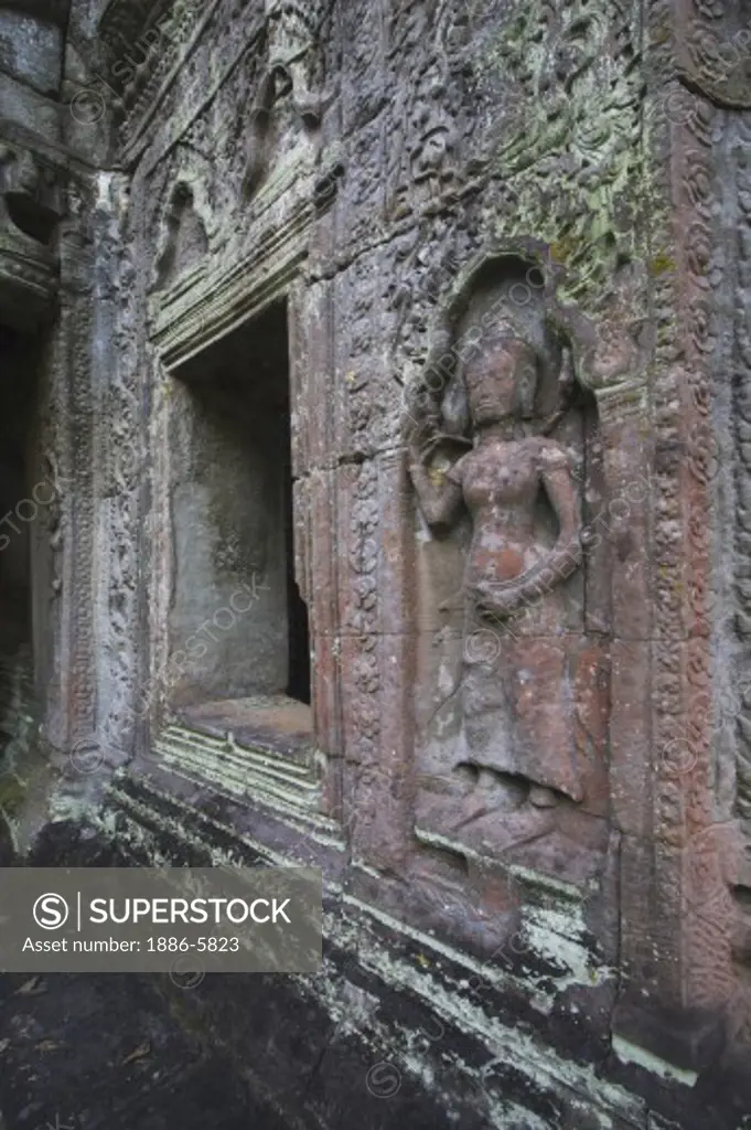 A stone carved bas relief of an Apsara (celestial mainden) at Ta Prohm, built by Jayavarman VII & part of the  Angkor Wat temple complex - Siem Reap, Cambodia   