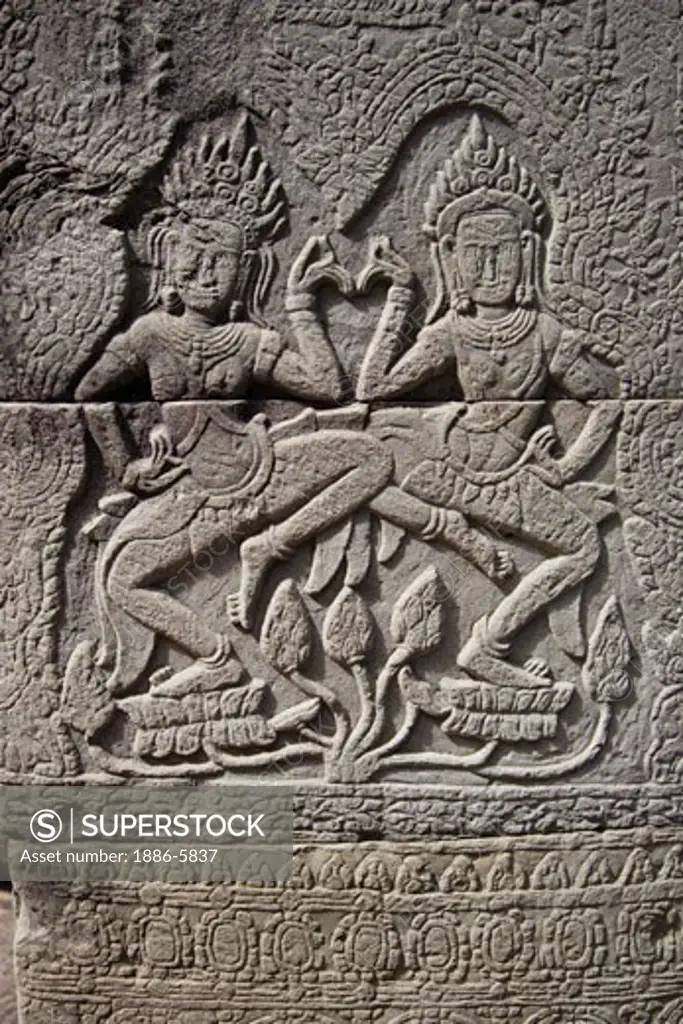 Stone carved bas relief of dancing Apsaras (celestial maidens) at Banteay Kdei, built by Jayavarman VII in the Bayon style, part of Angkor Wat - Siem Reap, Cambodia    