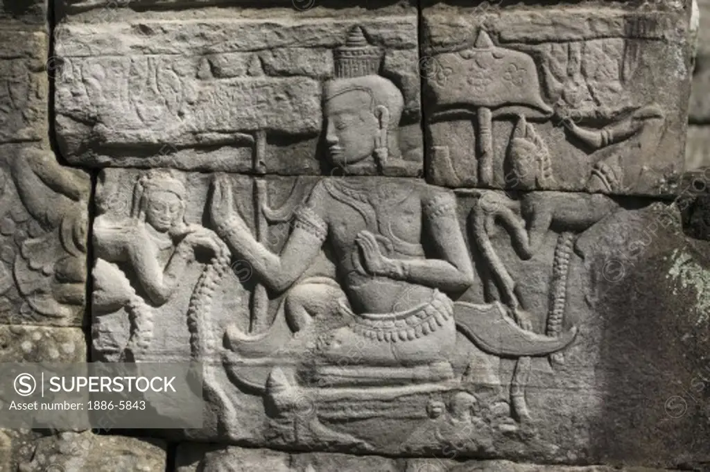 Sandstone bas relief of daily life with celestial angels on the walls of The Bayon, built by Jayavarman VII, in Angkor Thom  - Angkor Wat, Siem Reap, Cambodia   