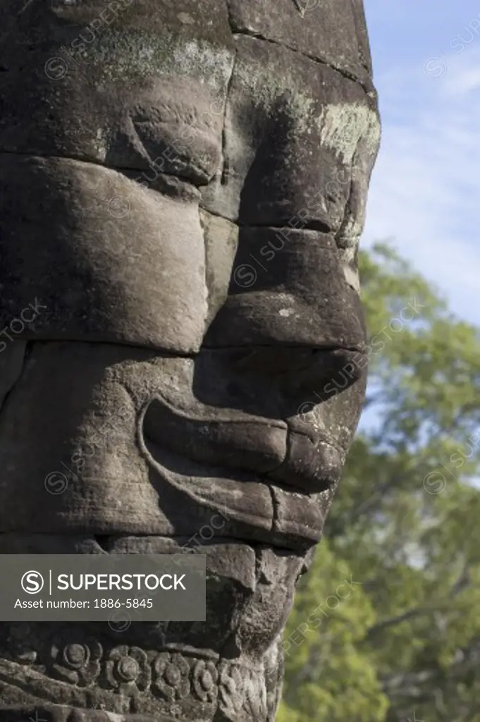 A close_up of a  face tower of The Bayon at Angkor Thom, the largest Khmer city ever built, are part of the Angkor Wat complex  -  Siem Reap, Cambodia  