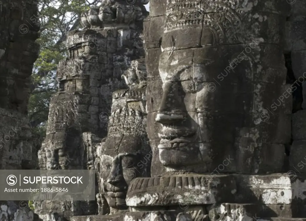 View of three face towers of The Bayon at Angkor Thom, the largest Khmer city ever built, are part of the Angkor Wat complex  -  Siem Reap, Cambodia   