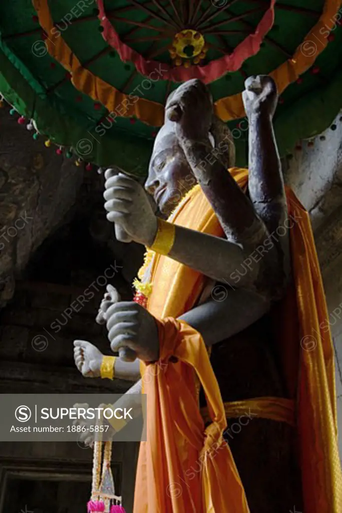 A stone carved statue of the Hindu god Vishnu in the outer gopura of Angkor Wat, built in the 11th century by Suryavarman the 2nd,  -  Cambodia 