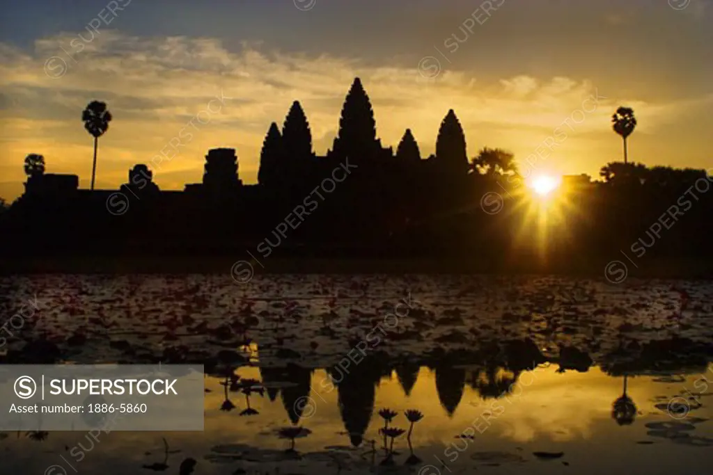 Stone temples representing the five peaks of Mount Meru reflected in a lotus pond at an Angkor Wat sunrise, built in the 11th century by Suryavarman II -  Siem Reap, Cambodia  