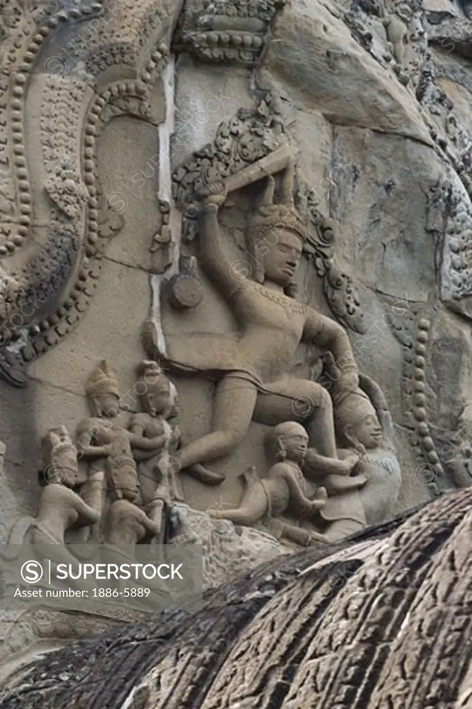 Stone carved bas relief of mythological Hindu god in battle at the ancient ruins of  Angkor Wat, built in the 11th century by Suryavarman the 2nd,  -  Cambodia  